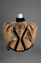 Back view of tan skating jacket with black Persian lamb collar, black braid and trim throughout…