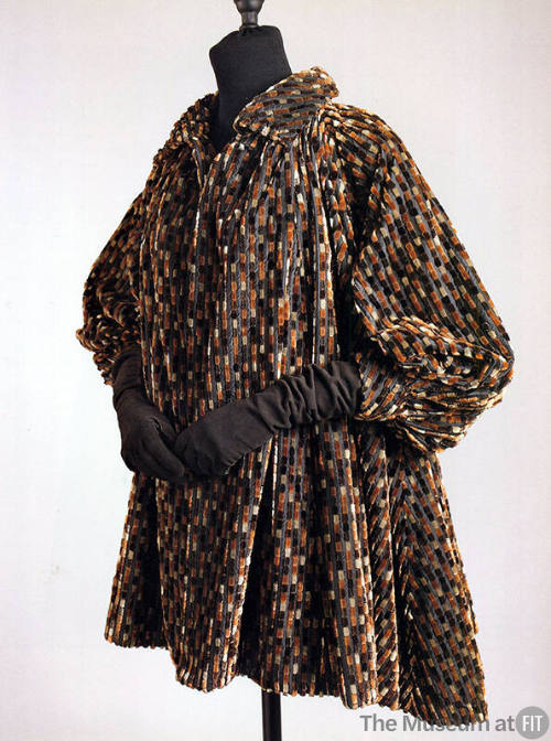 Tent style coat in broken stripes of grey, brown, tan and black velvet with cuffed puffed sleev…