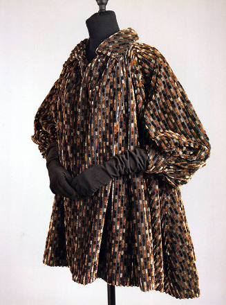 Tent style coat in broken stripes of grey, brown, tan and black velvet with cuffed puffed sleev…