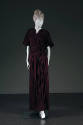 Purple floor length evening gown with intricately shirred shoulder yoke, high V-neck, elbow len…