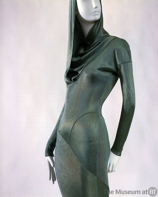Detail of green hooded form-fitting dress