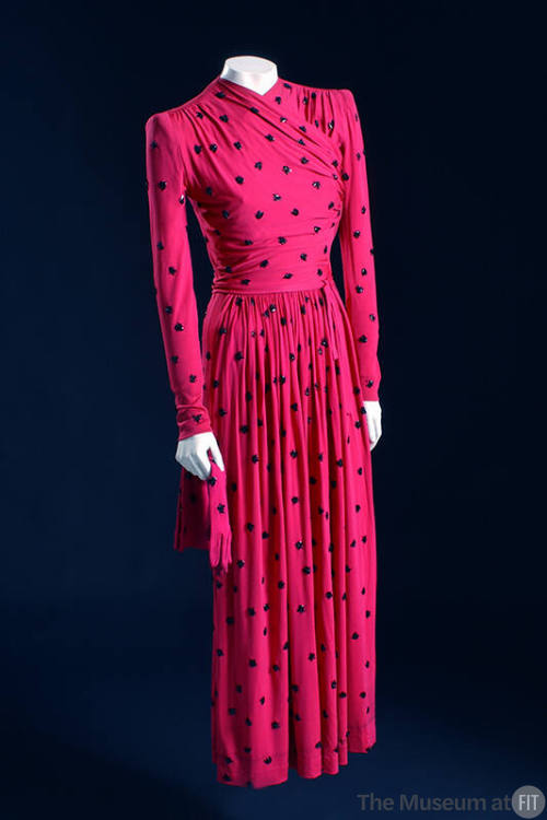 Pink long sleeve dress with allover black beaded flies, pleated skirt and matching gloves