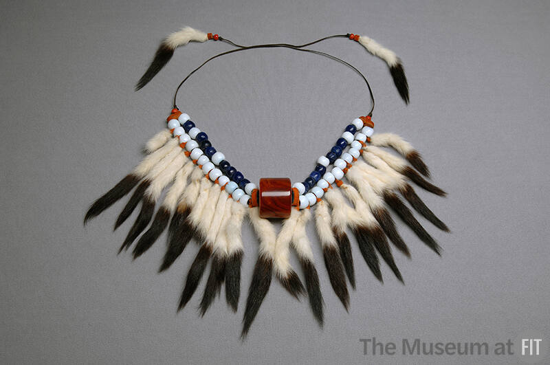 Blue and white beaded necklace with hanging fur tails on brown cord