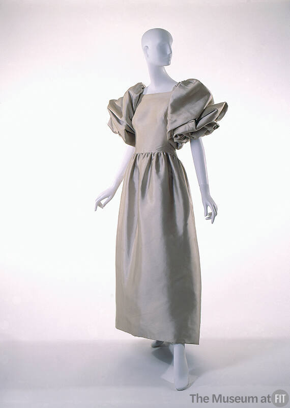Beige satin ankle length dress with large puffed draped sleeves to elbow, gathered waist
