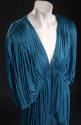 Detail of blue fully pleated dress, V-neck and drop three-quarter sleeves
