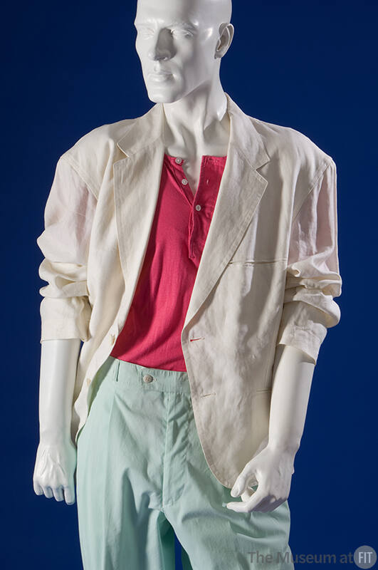 Detail of white jacket with wide lapels over pink three button t-shirt and light blue zip front…