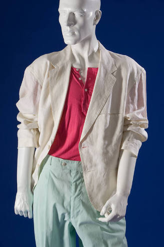 Detail of white jacket with wide lapels over pink three button t-shirt and light blue zip front…