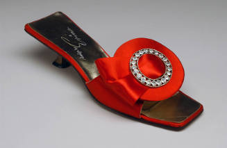 Red satin slide open toe sandal with wide front strap with circular ornament with center rhines…