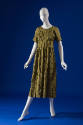Green calf length dress with overall grid pattern, round neck, short sleeves, semi fitted