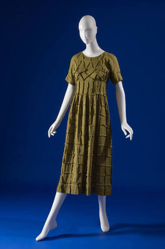 Green calf length dress with overall grid pattern, round neck, short sleeves, semi fitted