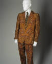 Multicolor paisley long sleeve suit jacket and matching pants over white shirt and black tie