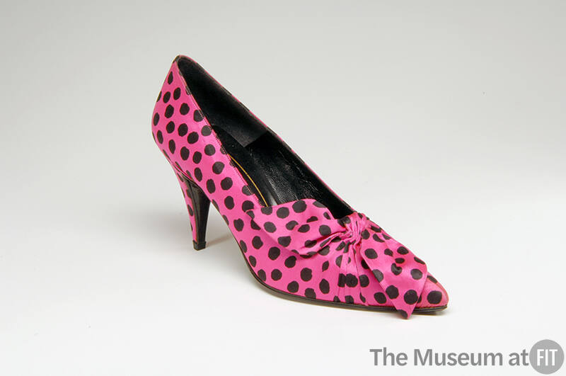 Pink high heel pump with allover black dots and front bow detail 