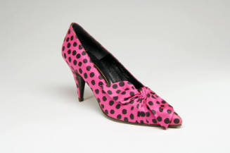 Pink high heel pump with allover black dots and front bow detail 