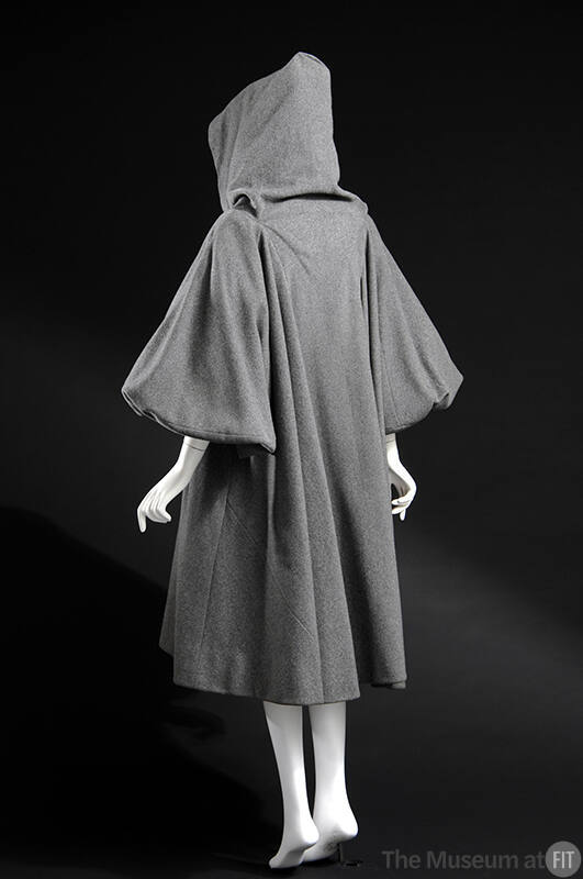 Back view of grey hooded below-the-knee coat with wide puffy 3/4 sleeves