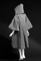 Back view of grey hooded below-the-knee coat with wide puffy 3/4 sleeves