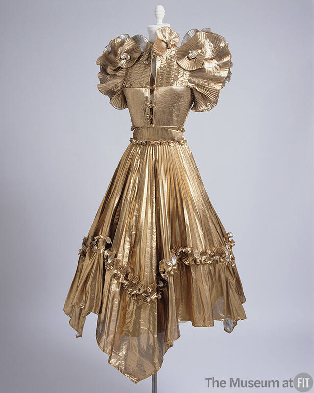 Gold lamé dress with vest bodice with ruffled pleated short sleeves and pleated skirt with asym…