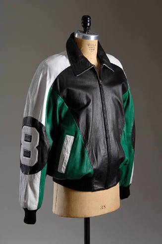 Black, white and green leather zip front jacket with large #8 in circle patch on long sleeve