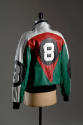 Back view of red, green, black, and white and leather jacket with large #8 in circle patch cent…