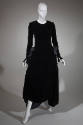 Long sleeve black velvet ankle length dress with large bows at gathered side hips