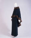 Green cashmere poncho with brown fur trim and floor length skirt
