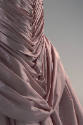 Detail of pink pleated dress skirt front 