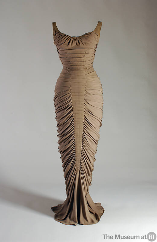 Taupe floor length evening dress with allover horizontal pleats and fishtail hem
