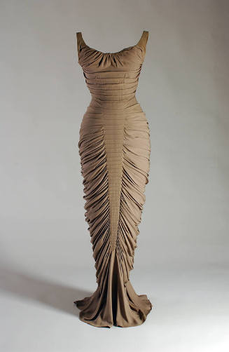 Taupe floor length evening dress with allover horizontal pleats and fishtail hem