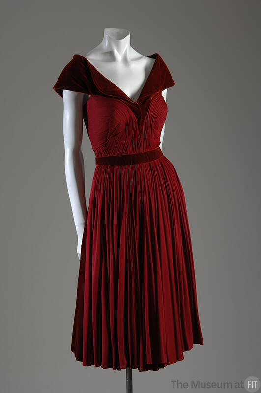 Red velvet knee length dress with silk ruched bodice and pleated skirt 