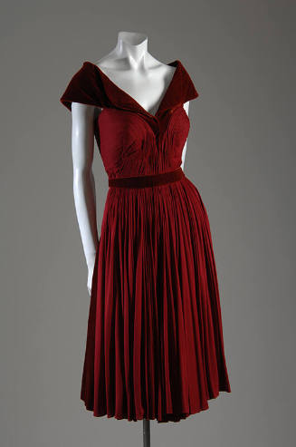 Red velvet knee length dress with silk ruched bodice and pleated skirt 