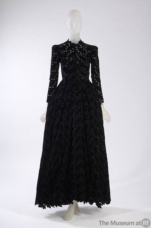 Black velvet floor length long sleeve dress with allover leaf cutouts 
