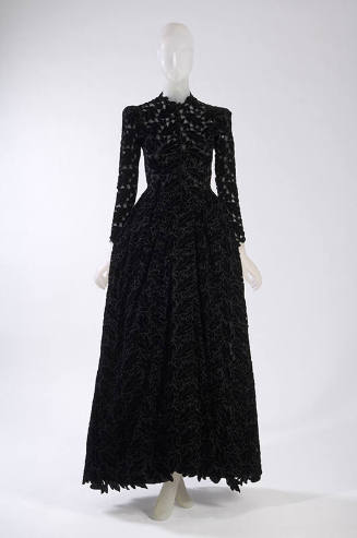 Black velvet floor length long sleeve dress with allover leaf cutouts 
