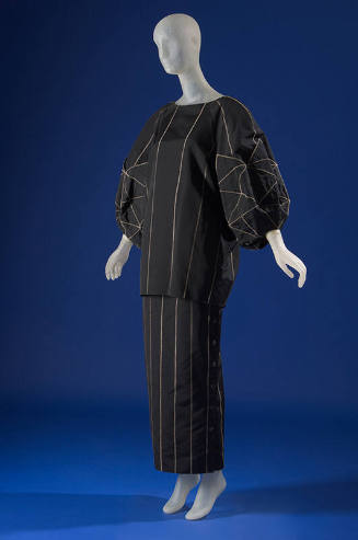 Black tunic top with long balloon sleeves, floor length skirt, both with grey topstitch details…