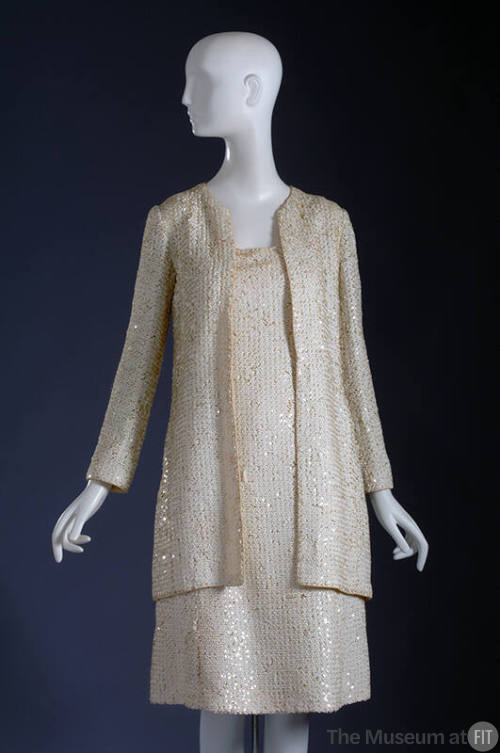 White sequinned long sleeve jacket and below-the-knee dress