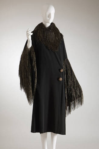 Black silk  coat with black and gold thread trim at neck and sleeves, two large off-center gold…
