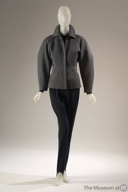 Grey long sleeve zip front jacket and black stirrup pants