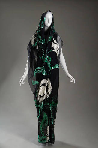 Dark blue floor length sari with sequined design of large white flowers and green leaves throug…