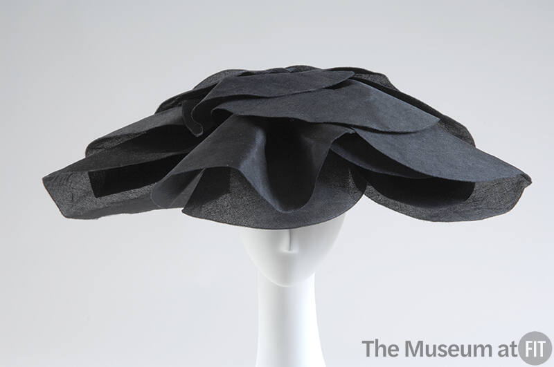 Large semicircular hat in black silk gazar with oversized petals for brim