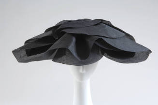 Large semicircular hat in black silk gazar with oversized petals for brim
