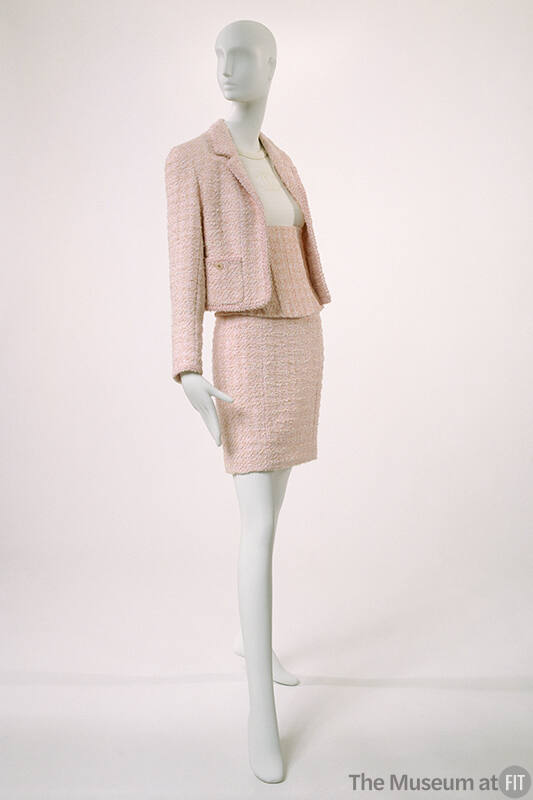 Stylized Chanel suit: cropped jacket, short skirt and boned corselet in pink textured tweed; wh…