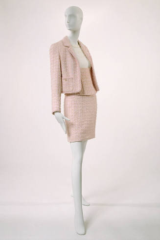 Stylized Chanel suit: cropped jacket, short skirt and boned corselet in pink textured tweed; wh…