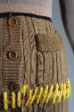 Detail of exposed whip stitching in yellow twisted yarn on brown cardigan sweater dress