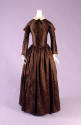 Brown day dress with floral patern, 3/4 length undersleeve with cap sleeve, and full skirt