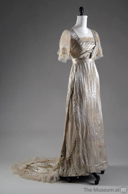 White silk silver lamé wedding dress with train and matching white silk satin shoes, both with …