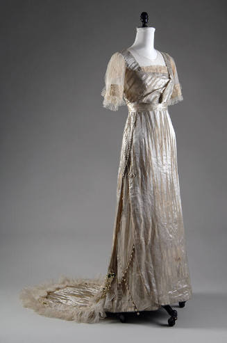 White silk silver lamé wedding dress with train and matching white silk satin shoes, both with …