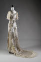 Back view of white silk silver lamé wedding dress with train