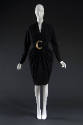 Black long sleeved dress with curved blck belt and large gold buckle