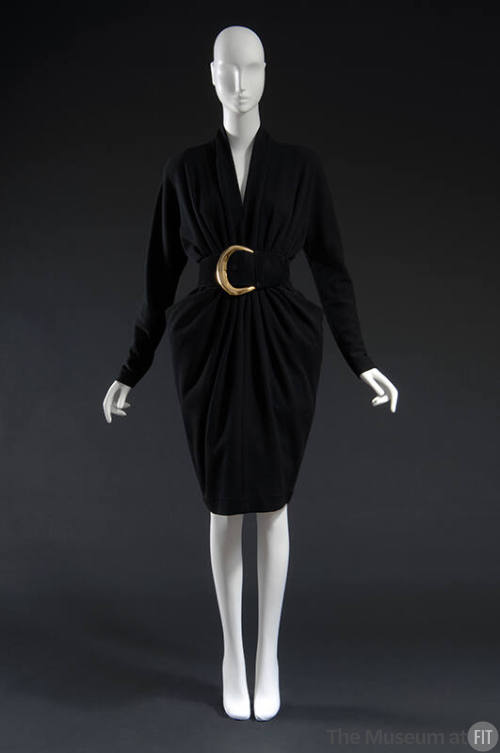 Black long sleeved dress with curved blck belt and large gold buckle