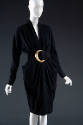 Black long sleeved dress with curved blck belt and large gold buckle