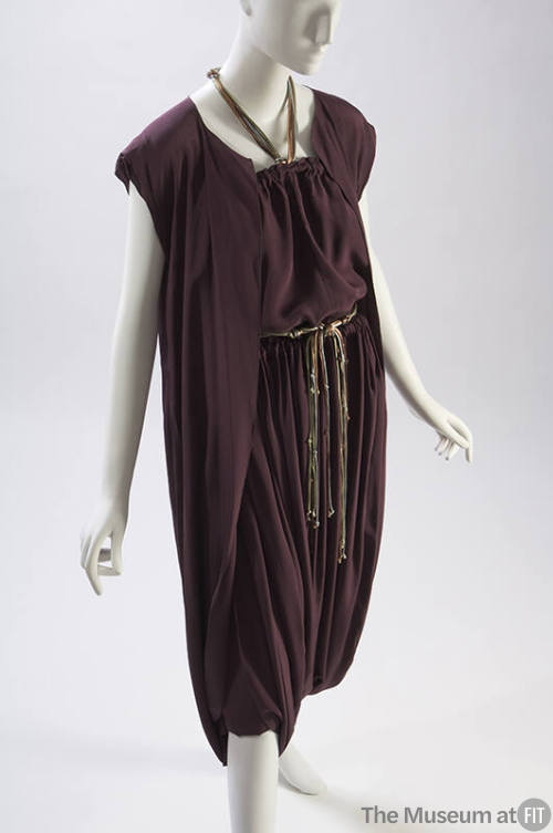 Purple top with side slits, matching skirt with drawstring waist and wrapped dhoti 

