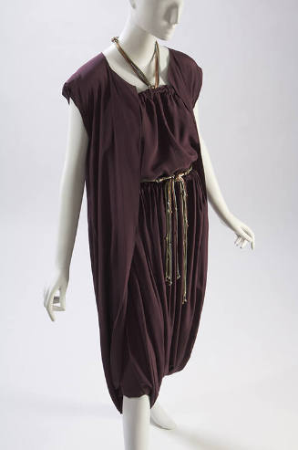Purple top with side slits, matching skirt with drawstring waist and wrapped dhoti 

